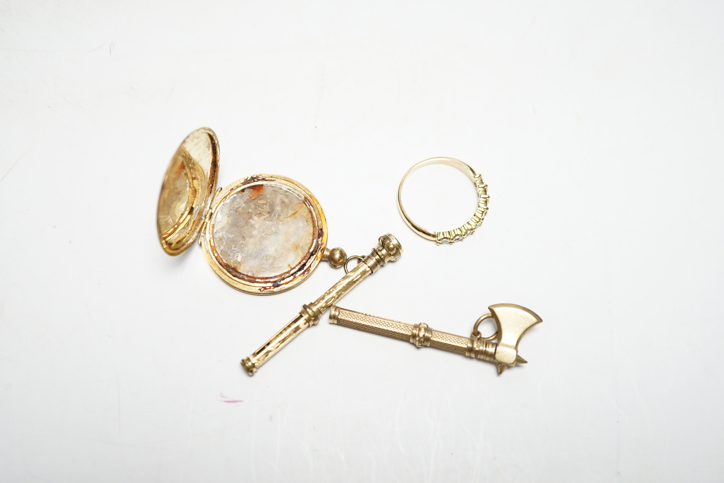 A yellow metal (stamped 18) locket (a.f.), a yellow metal and illusion set diamond chip half eternity ring and two other items.